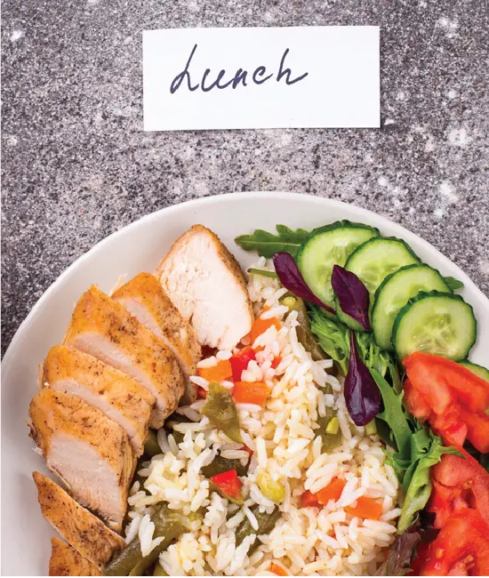 Healthy lunch plate with grilled chicken, rice, salad and vegetables prepared during Acals cooking class for NDIS participants in Sydney