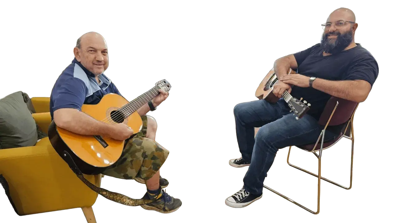 NDIS participant and guitar instructor Rai playing acoustic guitars during a guitar lesson at Acals