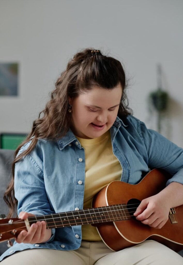 woman with Down syndrome in guitar lessons